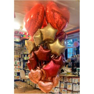 Huge balloon bunch of 30 foil hearts and stars, with 3 big red heart balloons on top.